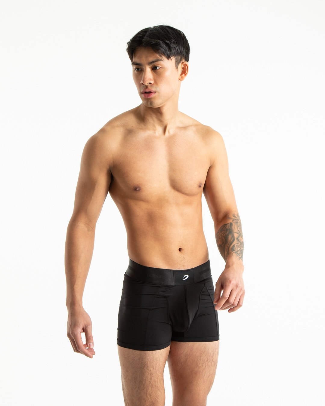 Man in black nylon slim fit boxers with white strike logo on waistband
