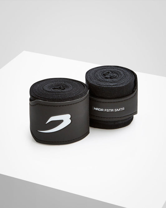 Black fabric boxing handwraps that is 4.5 metres in length with a leather velcro strap embossed with a white boxraw strike logo.