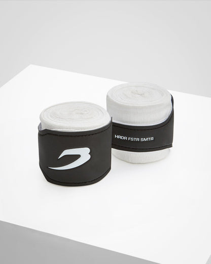 White fabric boxing handwraps that is 4.5 metres in length with a leather velcro strap embossed with a white boxraw strike logo.