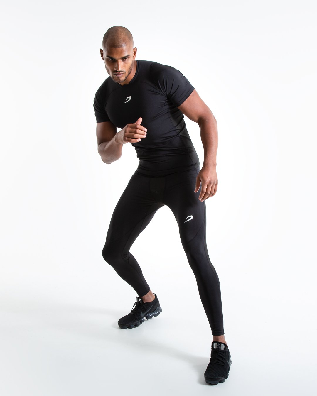 Man in black compression long sleeved t-shirt made from mesh fabric and targeted ventilation panels with white boxraw strike logo on the chest.