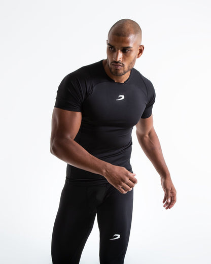 Man in black compression long sleeved t-shirt made from mesh fabric and targeted ventilation panels with white boxraw strike logo on the chest.