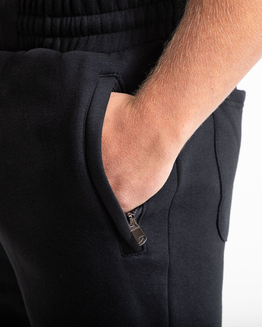 Man in black tracksuit style shorts with a white 3D boxraw logo as well as side zipped pockets made from a cotton/poly blend.