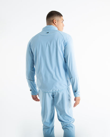 Man in baby blue zipped lightweight tracksuit jacket with a hidden zipped hoodie with black boxraw logo made from polyester.
