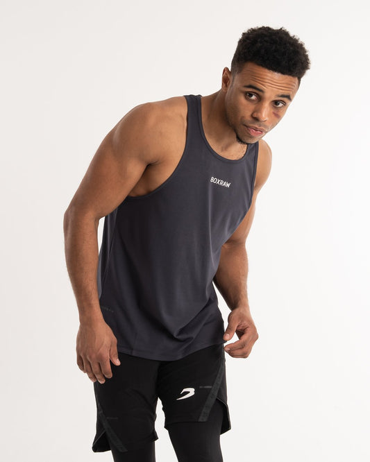 man wearing charcoal dark grey boxraw performance stringer tank top