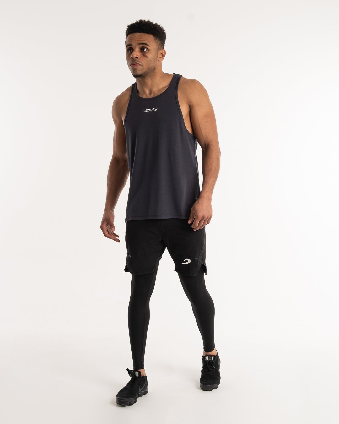 man wearing charcoal dark grey boxraw performance stringer tank top