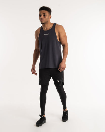 man wearing charcoal dark grey boxraw performance stringer tank top