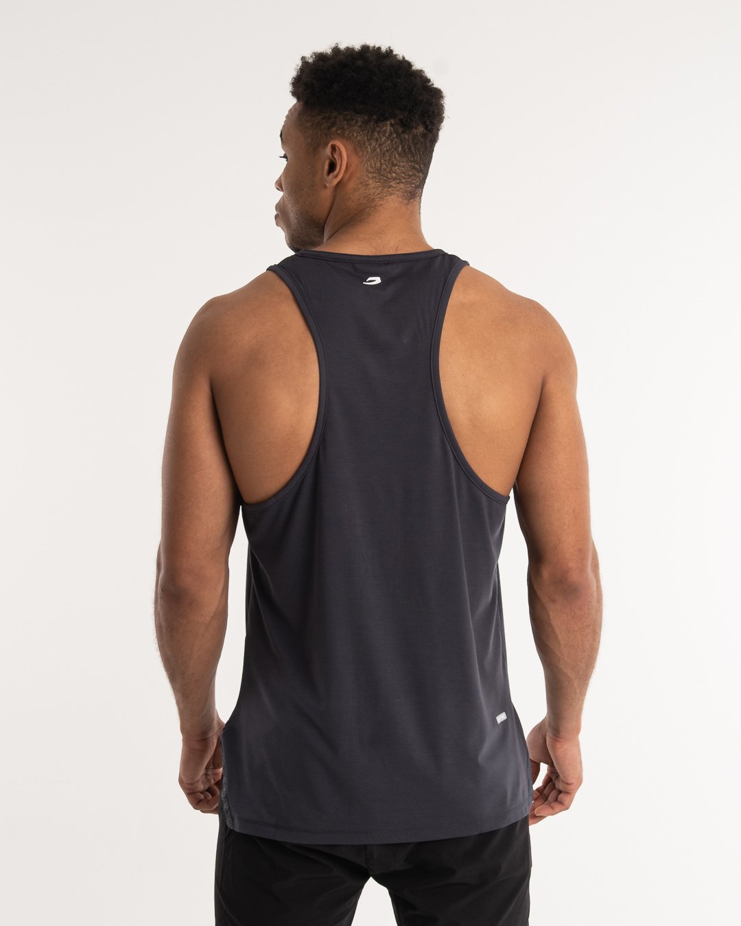man wearing charcoal dark grey boxraw performance stringer tank top