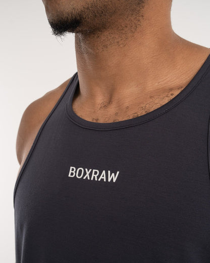 man wearing charcoal dark grey boxraw performance stringer tank top