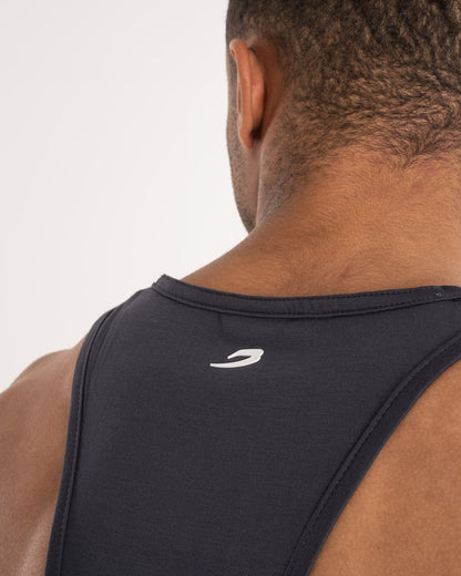 man wearing charcoal dark grey boxraw performance stringer tank top