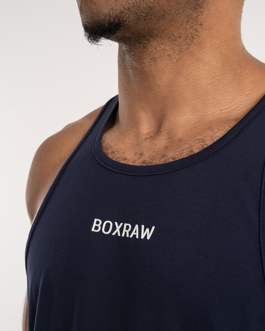 man wearing navy dark grey boxraw performance stringer tank top