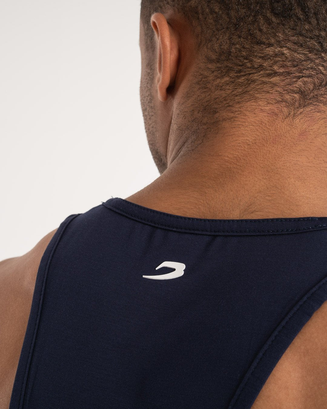 man wearing navy dark grey boxraw performance stringer tank top
