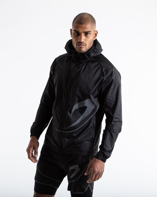 Man in black zipped windbreaker with hood and reflective big boxraw strike logo across left body panel made from nylon.
