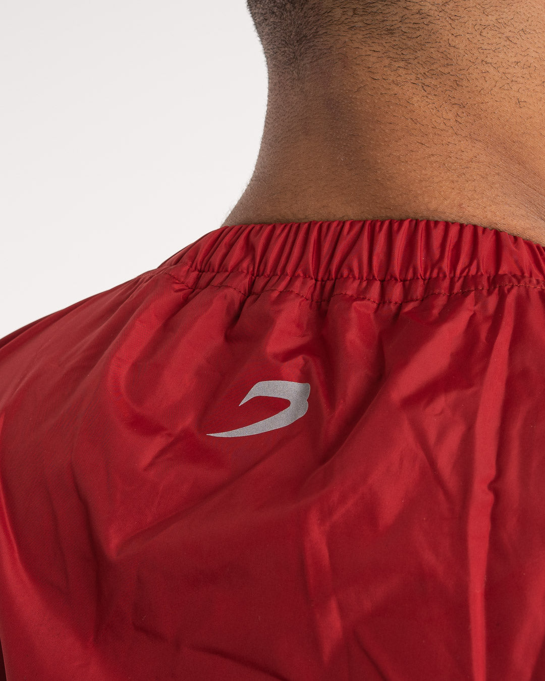 Man in a red sauna suit tracksuit with a white boxraw logo on the chest as well as adjustable wrist straps and made from polyester.