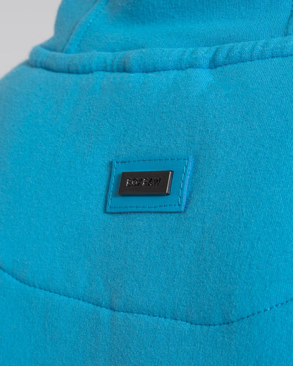 Women in a boxraw baby blue jumper with hood & kangaroo pocket made from cotton with the boxraw strike logo in white on the front and large 36 number on the back.