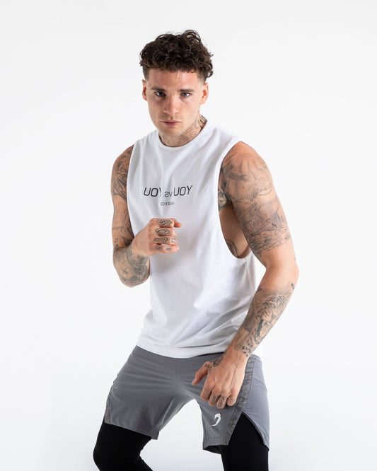 Man in white slim fit cotton muscle tank with reversed you vs you text in black on chest.