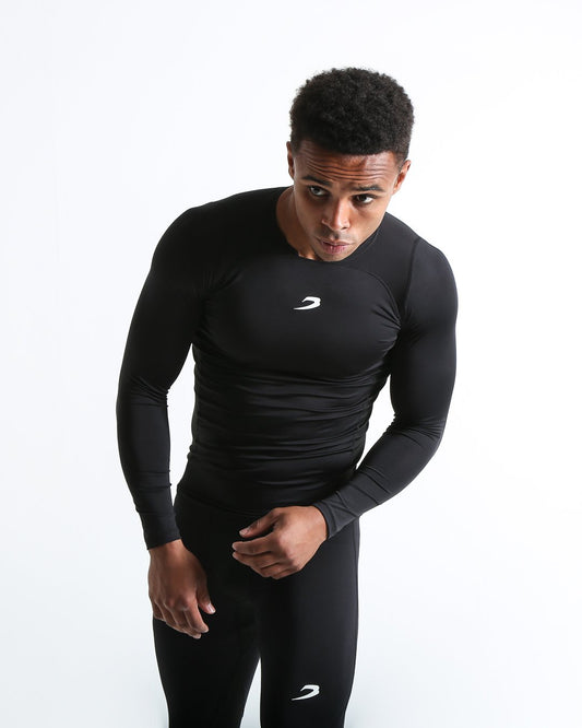 Man in black compression long sleeved t-shirt made from mesh fabric and targeted ventilation panels with white boxraw strike logo on the chest