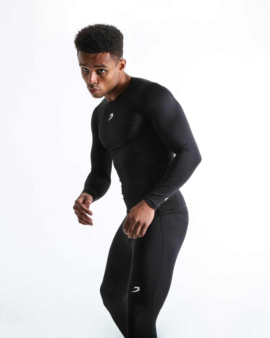 Man in black compression long sleeved t-shirt made from mesh fabric and targeted ventilation panels with white boxraw strike logo on the chest