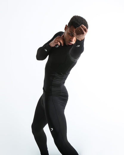 Man in black compression long sleeved t-shirt made from mesh fabric and targeted ventilation panels with white boxraw strike logo on the chest