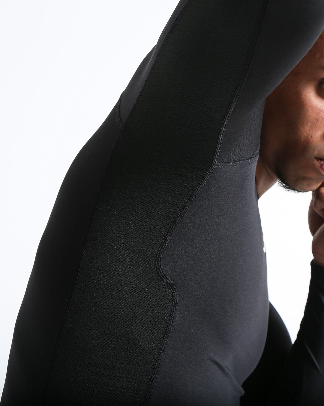 Man in black compression long sleeved t-shirt made from mesh fabric and targeted ventilation panels with white boxraw strike logo on the chest