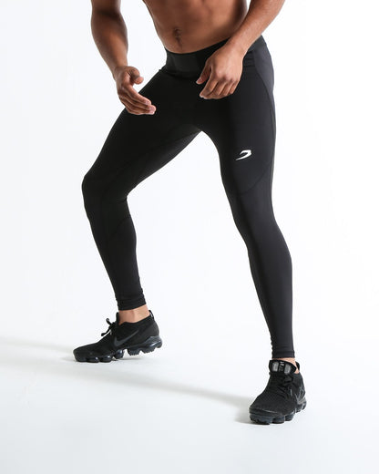 Man in black compression leggings/tights with wide elastic waistband and a white 3D strike logo on the leg.