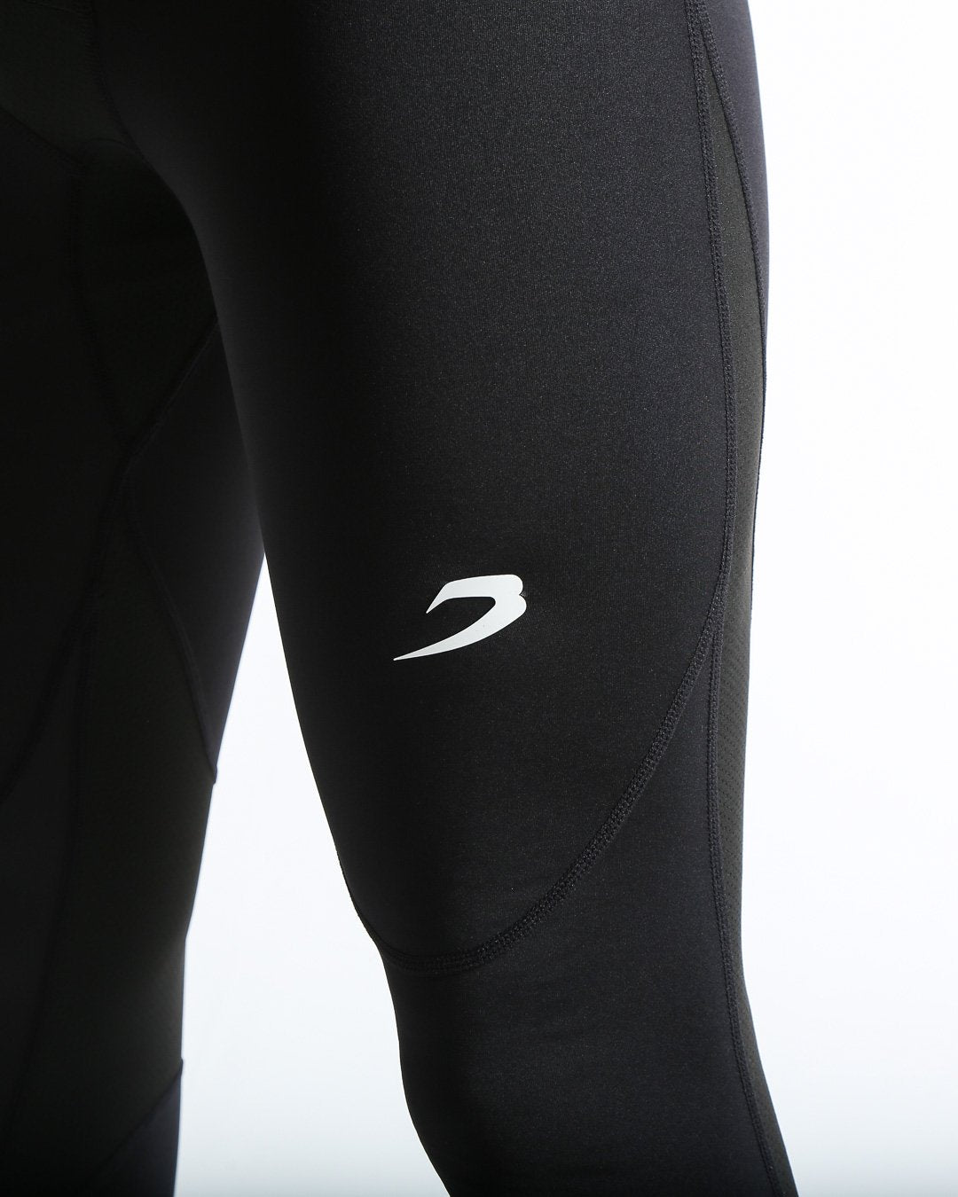 Man in black compression leggings/tights with wide elastic waistband and a white 3D strike logo on the leg.